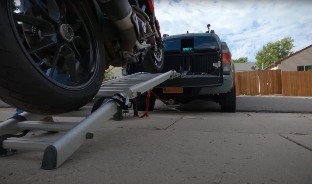 loading a motorcycle into the back of a pickup truck